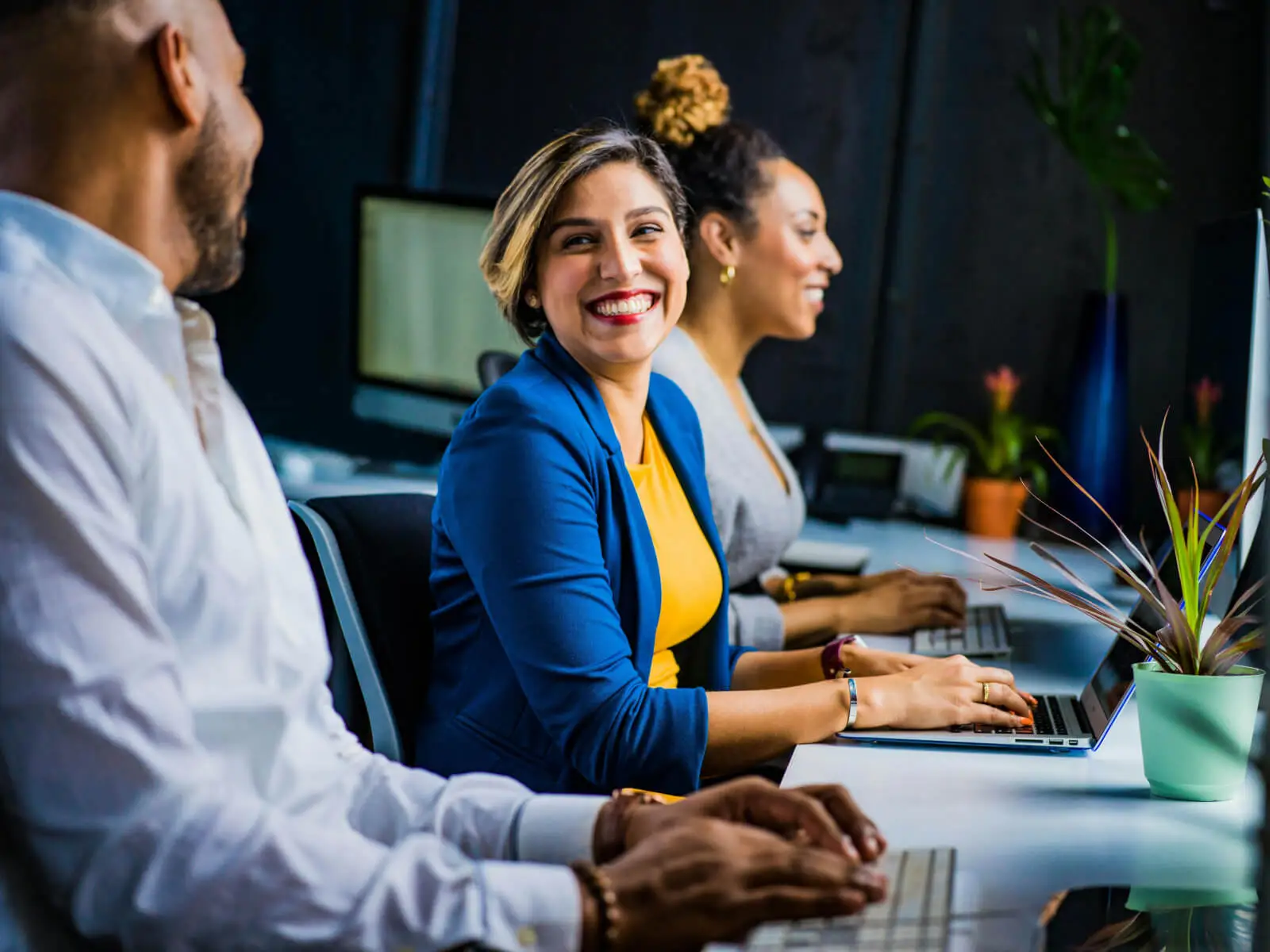 A woman smiling at her male coworker.